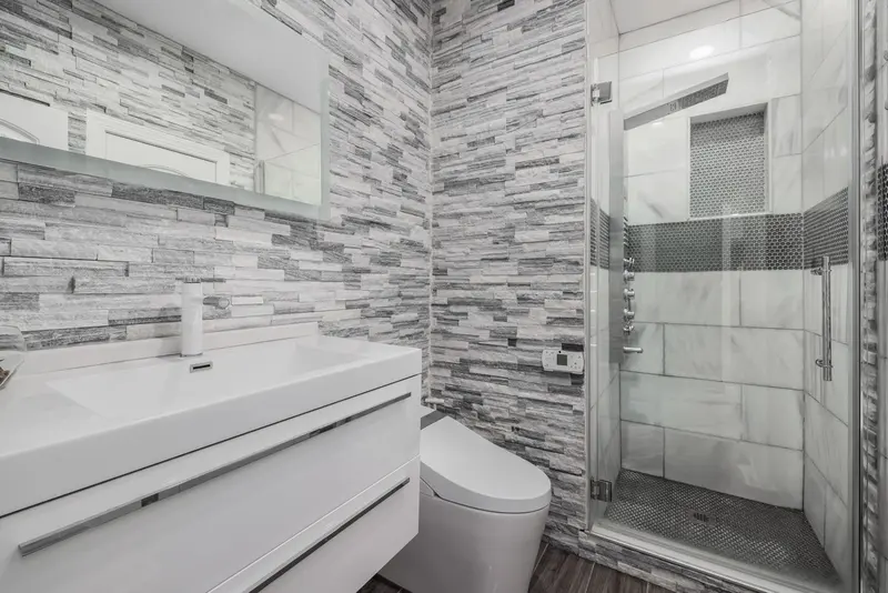 Bathroom with a stone-walled walk-in shower and modern vanity
